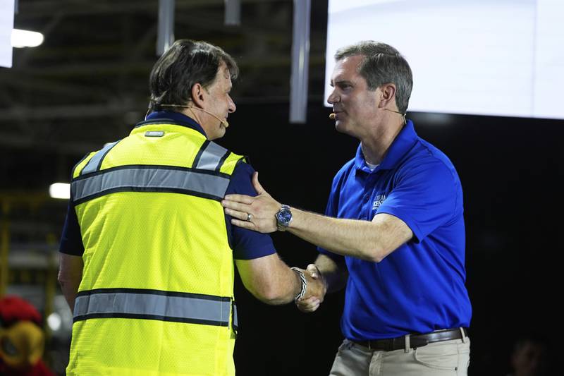 Ford CEO Jim Farley (left) shakes hands with Kentucky Governor Andy Beshear at the Louisville Assembly Plant in Louisville, Kentucky.