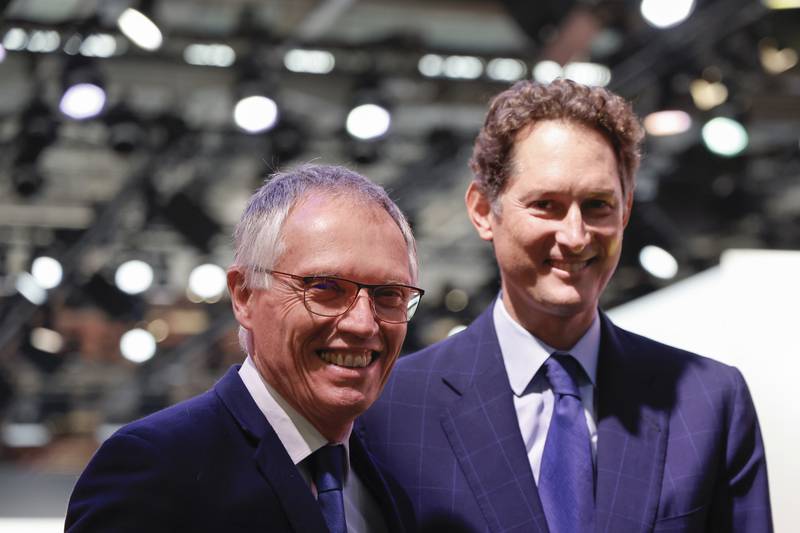 Stellantis chairperson John Elkann (right) and former Stellantis CEO Carlos Tavares attend the Paris Auto Show in October 2024.