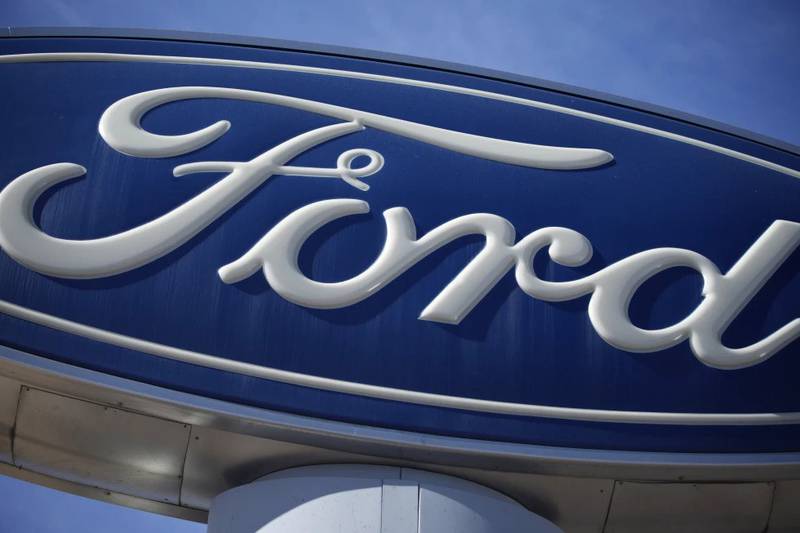 The Ford company logo is seen on a sign at a Ford dealership in southeast Denver.