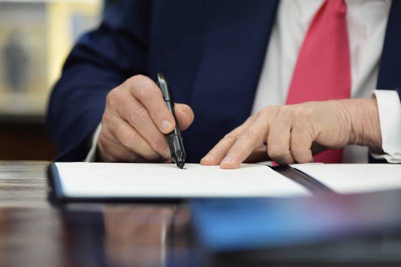 President Donald Trump signs a proclamation in the Oval Office honoring the 90th anniversary of the Social Security Act.