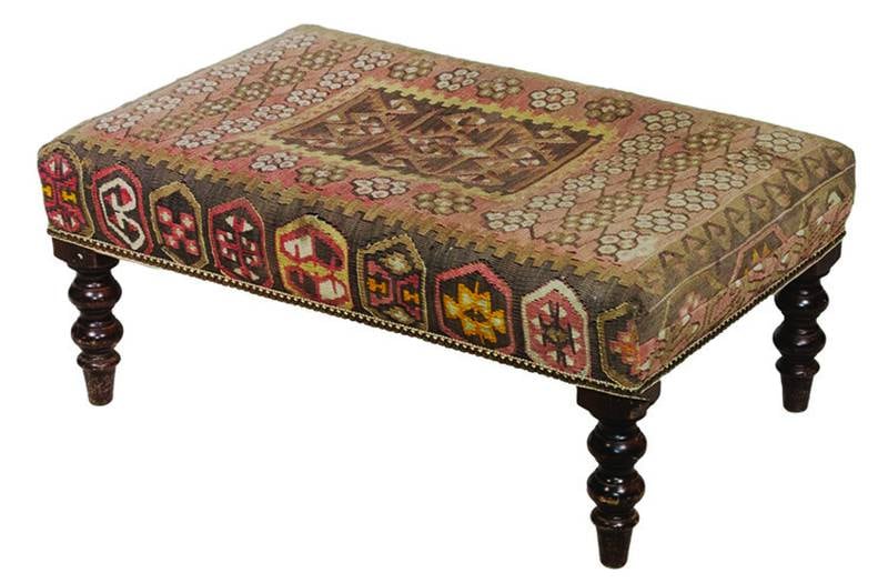 Rugs aren't just for covering the floor. An antique kilim rug, a style originating in Western Asia, found another life as upholstery for a 20th-century bench.