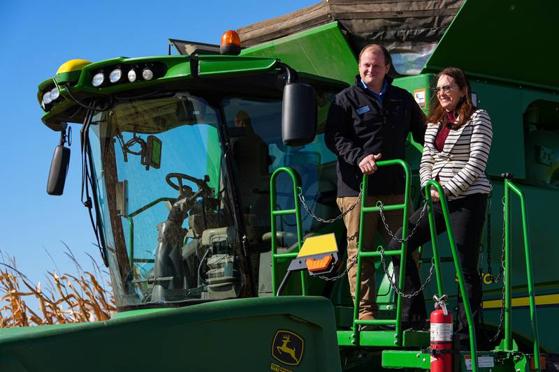 U.S. Secretary of Agriculture Brooke Rollins (right) films a social media post on a combine with farm owner Tyler Everett during a farm tour in Lebanon in central Indiana.