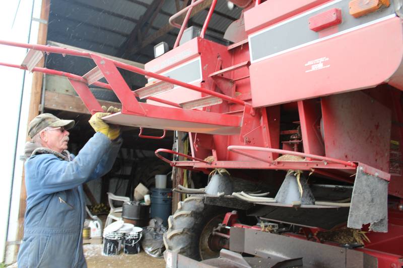 Marvin Frederick closes the ladder on his combine after completing maintenance checks. The Army veteran was drafted when he was 20 years old and returned home to farm with his dad after completing his military service.