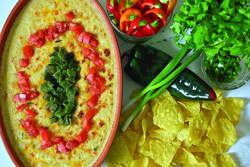 A bubbling dish of chicken queso fundido, loaded with flavor and perfect for sharing.