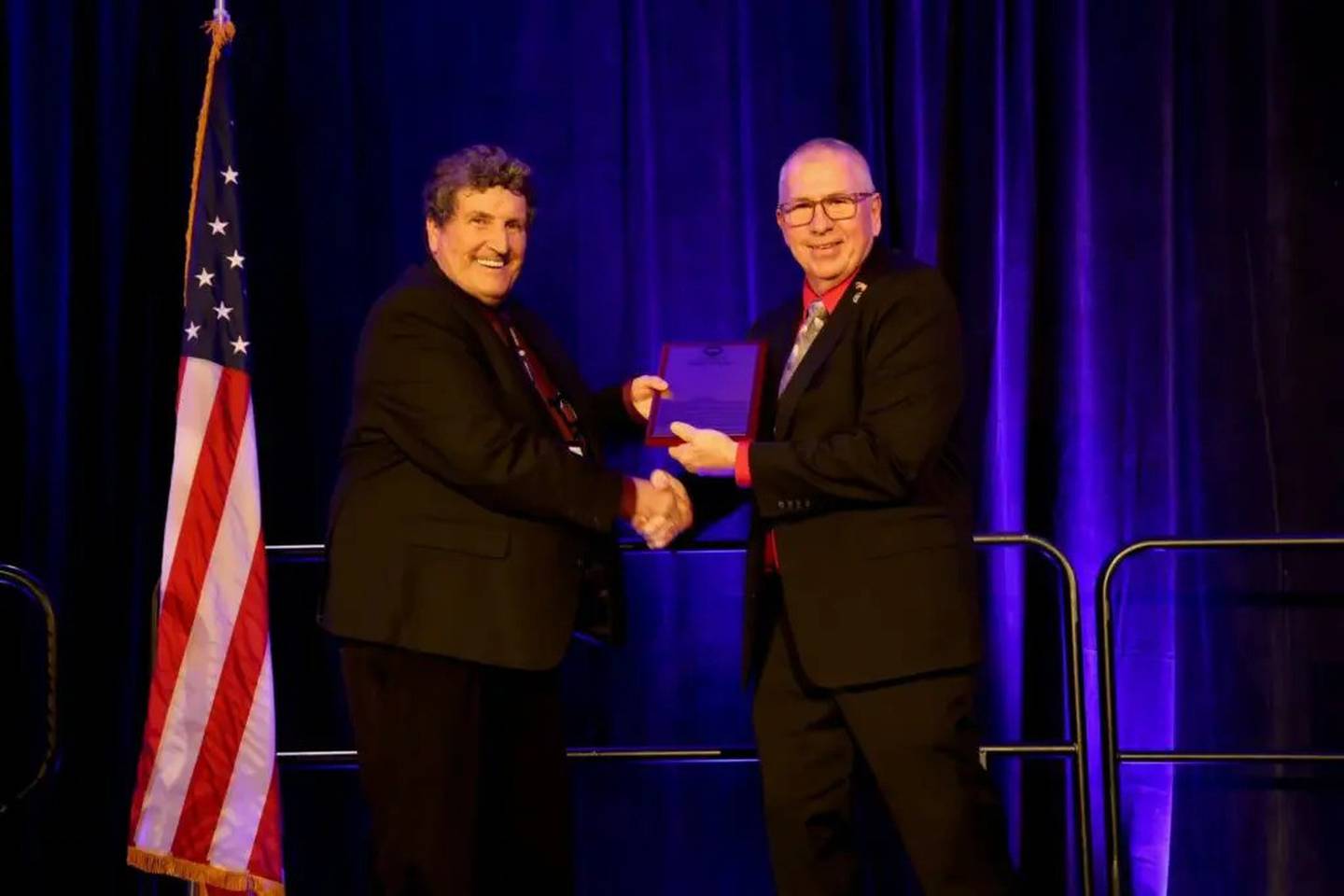 Sam Carney (left), former president of the National Pork Producers Council, is presented with the Pork Industry Hall of Fame award in recognition of his contributions to the pork industry from Duane Stateler, immediate past president of the NPPC.