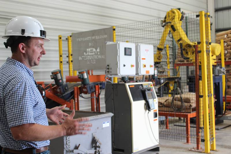 Leon Peters explains how the JEM robotic stacker works at the University of Illinois Feed Technology Center. This robot reduces the amount of people needed for the bagging process, as well as provides a consistent stack on the palette for transportation.