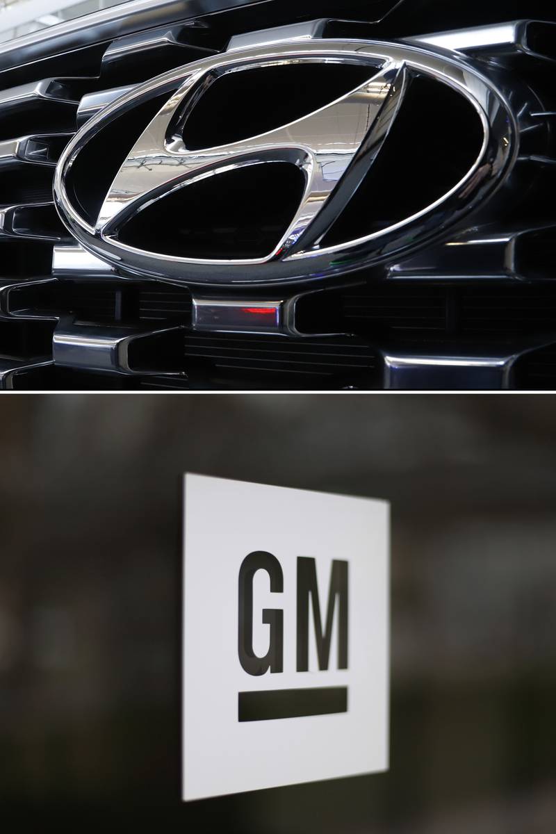 This combo of file photos shows the logo of Hyundai at the 2020 Pittsburgh International Auto Show Thursday, Feb.13, 2020 in Pittsburgh, top, and the General Motors logo at the company's world headquarters in Detroit on May 16, 2014.