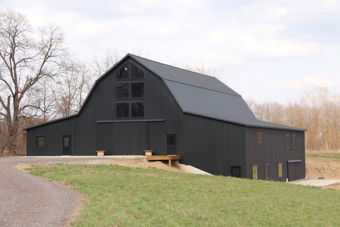 The Hay Barn is a beautifully preserved 1903 multi-generational family barn 30 minutes southeast of Shipshewana, Indiana. Owned by Jon Bovee of Stroh, the barn was originally slated for demolition. However, due to its remarkable condition, Bovee and his wife disassembled and transported it piece by piece to their own land. A few original posts were replaced at a local sawmill in LaGrange County. It was meant to serve as a storage space for hay and equipment, but as it was rebuilt, its charm didn’t go unnoticed. Encouraged by the community, Bovee and his wife are transforming the barn into a wedding and event venue.