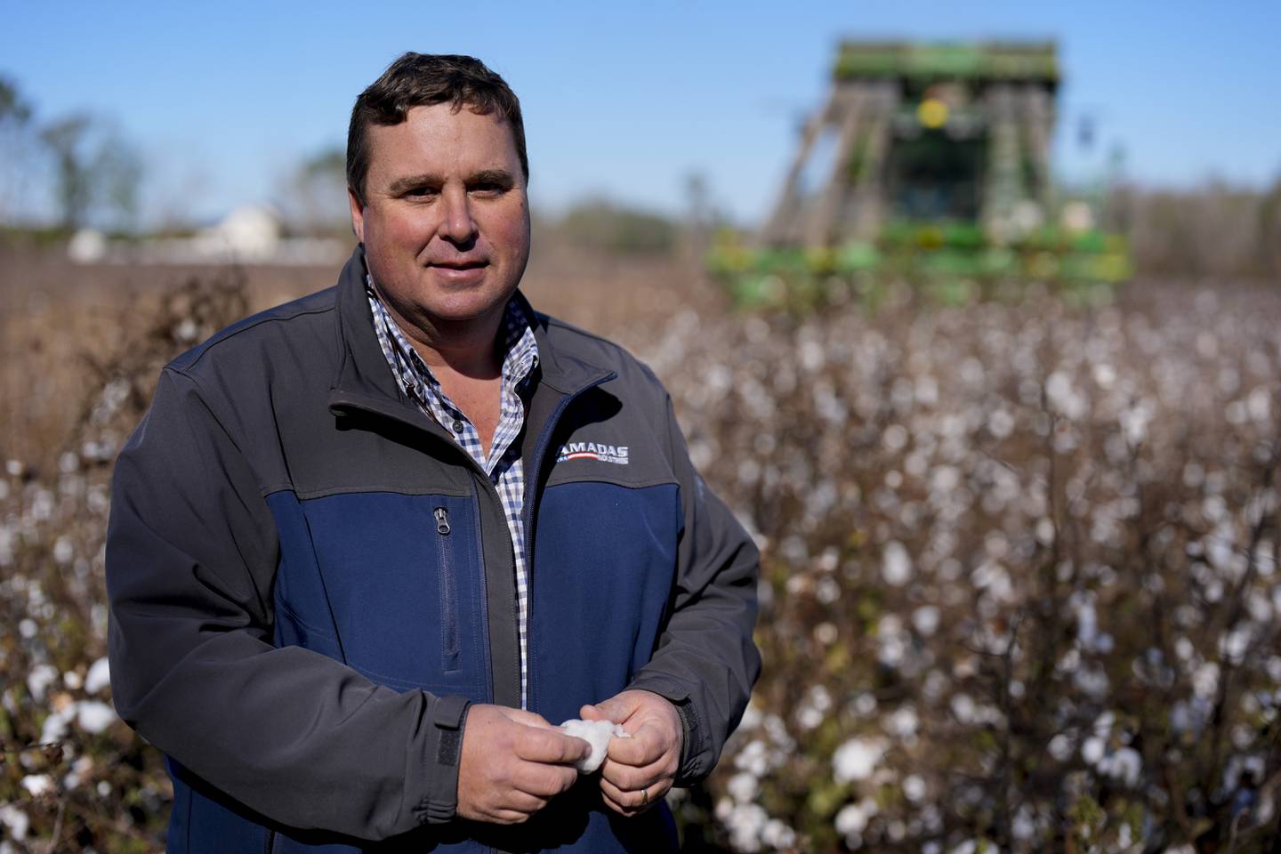 Farmer Chris Hopkins stands in one of his cotton fields before being harvested near Lyons, Georgia.