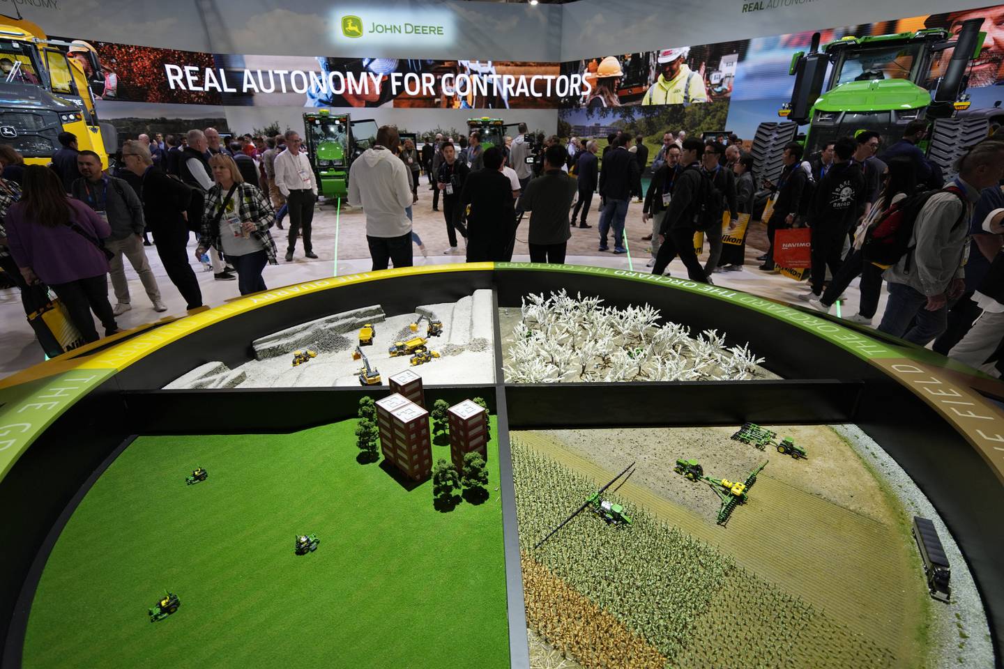 People visit the John Deere booth during the CES tech show in Las Vegas.