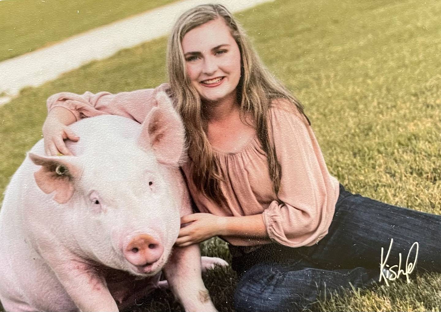 “Dolly” — Shelby Gillis: “4-H member Shelby Gillis and her Yorkshire gilt, Dolly.”