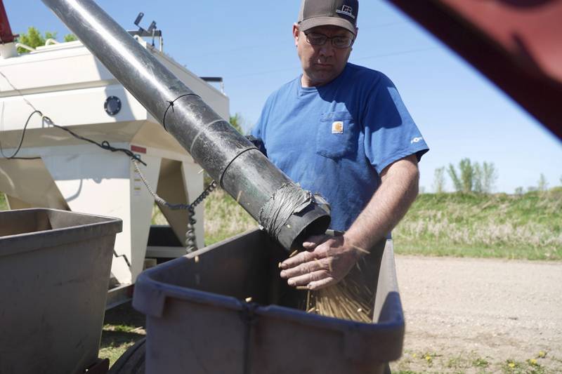 Minnesota Farm Bureau president Dan Glessing loads soybeans into his planter.