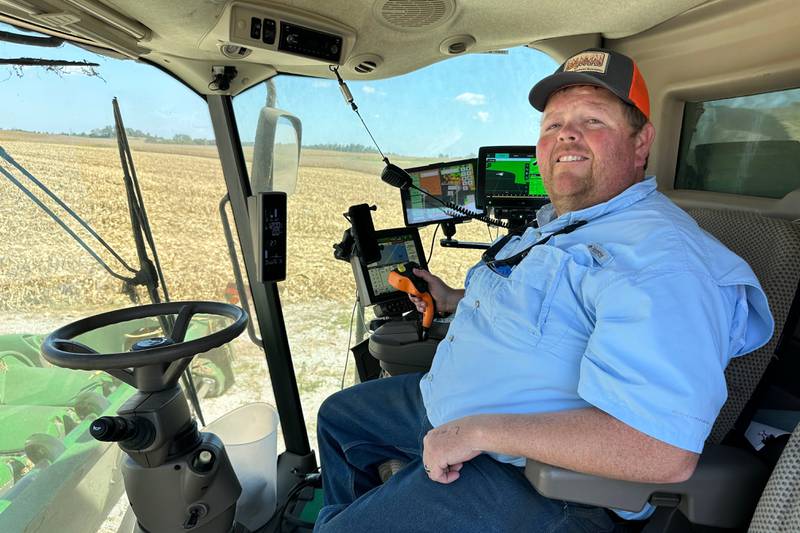 Kentucky farmer Caleb Ragland sits in his combine while harvesting corn.