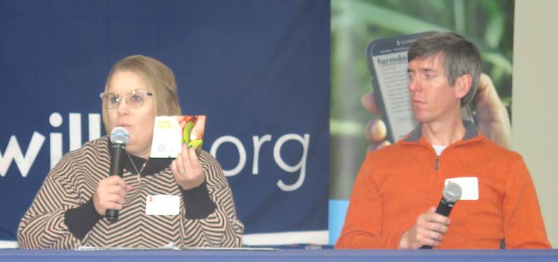 Stephanie Porter, Illinois Soybean Association outreach agronomist, shows a card with information on ISA's Soybean Production Concerns Survey. The survey guides ISA in determining areas of research needed to address farmers' concerns. Porter and Nick Seiter, University of Illinois entomologist, were panelists at the recent Farm Assets Conference.