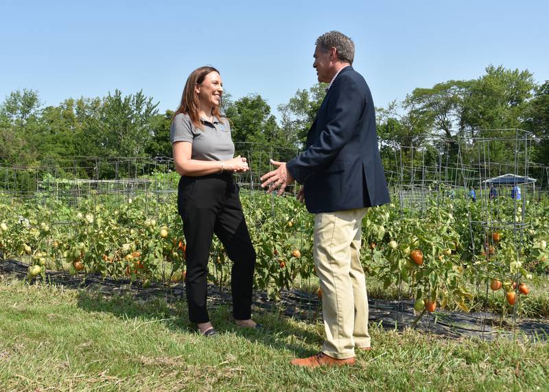 Audrey Grimm, senior vice president and chief human resources and diversity officer at Corteva Agriscience, and Don Lamb, the director of the Indiana State Department of Agriculture, chat in the Harvest for Hunger garden created by the company’s employees in 2014. They recently celebrated donating 100,000 pounds of produce during that decade.
